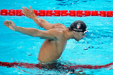 Thomas Ceccon celebrates after winning the men's 100-meter backstroke final